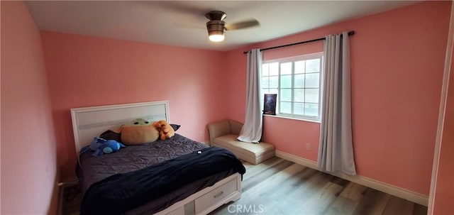 bedroom with light hardwood / wood-style flooring and ceiling fan