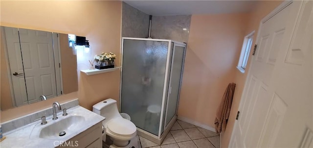 bathroom with tile patterned flooring, vanity, toilet, and a shower with shower door