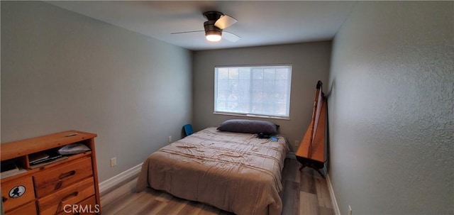 bedroom with ceiling fan and light hardwood / wood-style floors