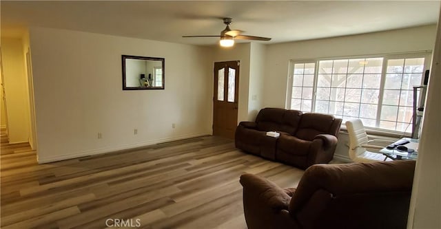 living room with ceiling fan and light hardwood / wood-style flooring