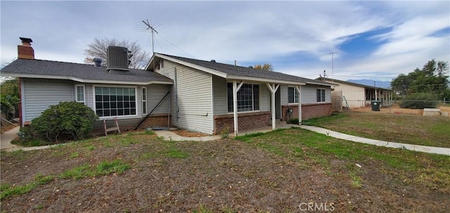 exterior space with a front yard and cooling unit