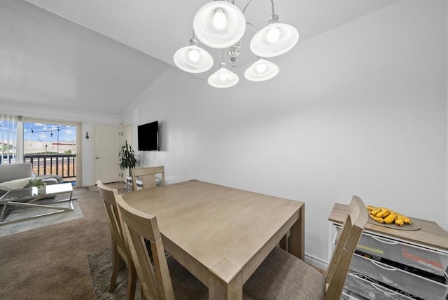 dining area featuring dark carpet, lofted ceiling, and an inviting chandelier