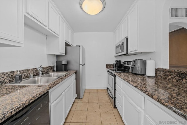 kitchen with stainless steel appliances, white cabinetry, and sink