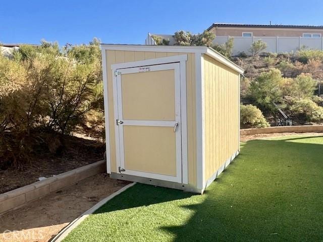 view of outdoor structure featuring a lawn