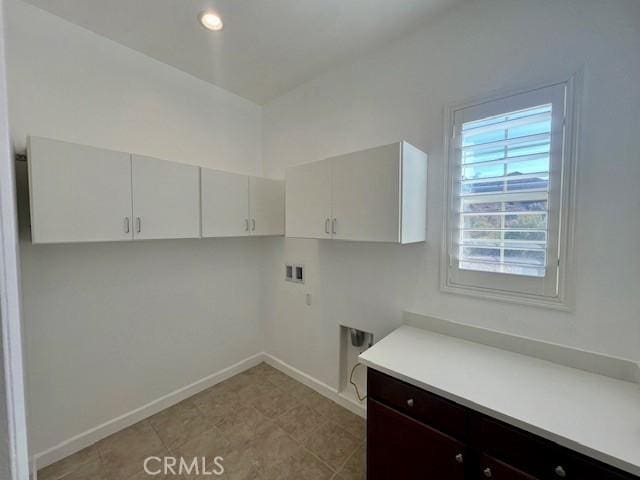 laundry area with washer hookup, cabinets, and electric dryer hookup