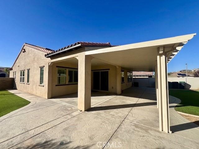 back of property featuring a carport