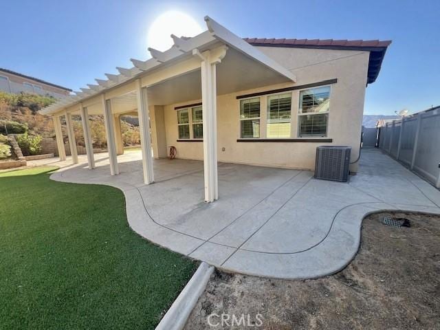 back of house featuring a patio area, central AC, and a yard