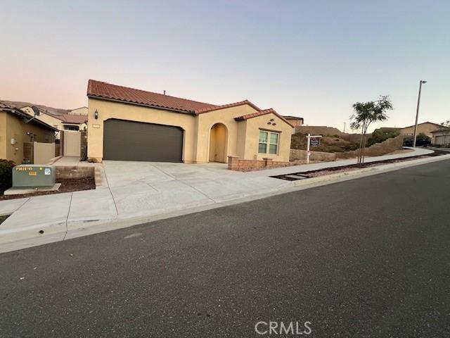 mediterranean / spanish home with a garage