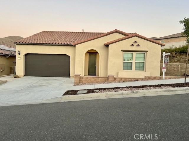 mediterranean / spanish-style house with a garage and central air condition unit