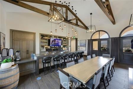 dining area with high vaulted ceiling and beamed ceiling