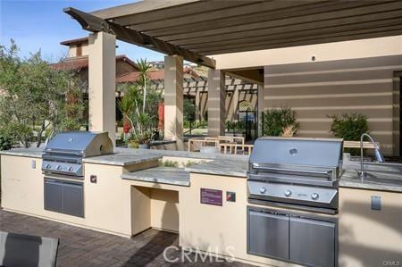 view of patio / terrace featuring sink, an outdoor kitchen, and area for grilling