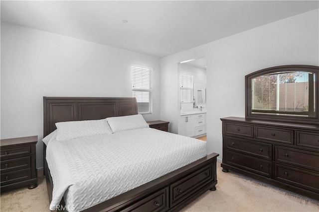 carpeted bedroom with connected bathroom