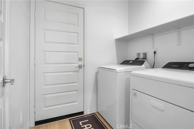 washroom with independent washer and dryer