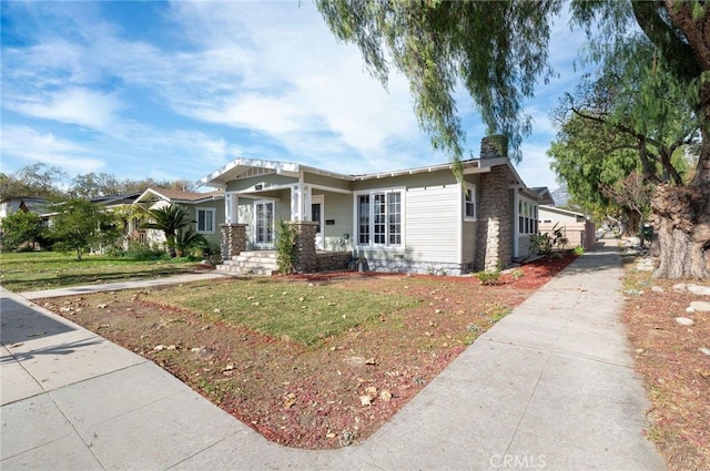 view of front of house featuring a front yard and a porch