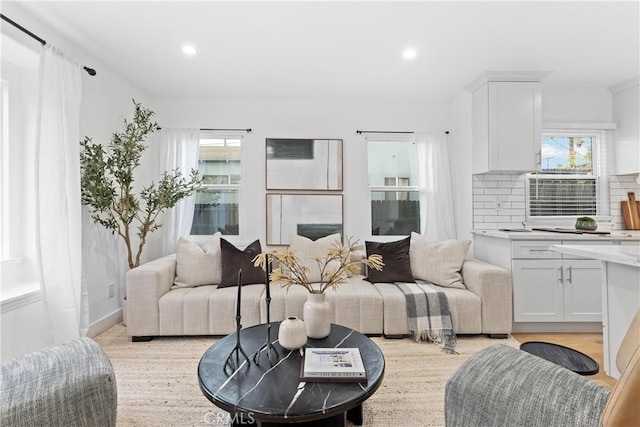 living room with a wealth of natural light and light wood-type flooring