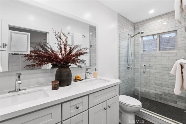 bathroom featuring vanity, toilet, tile patterned floors, and a shower with door