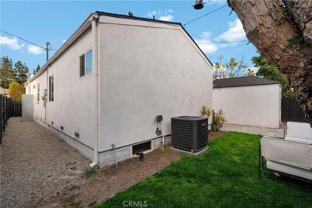 view of home's exterior with cooling unit and a yard