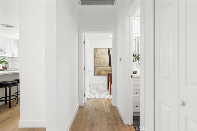 corridor with light wood-type flooring