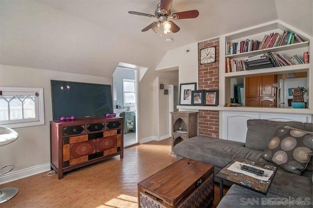 living room featuring ceiling fan, built in features, light hardwood / wood-style floors, and vaulted ceiling