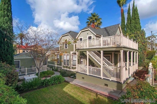 rear view of house with a lawn