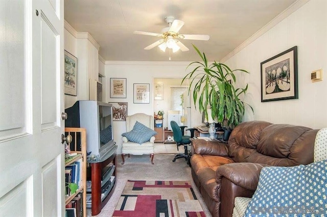 living room featuring carpet, ceiling fan, and crown molding