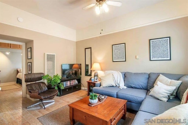 living room with wood-type flooring and ceiling fan