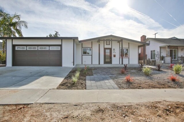 ranch-style house featuring a porch and a garage