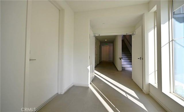 hall featuring light tile patterned flooring