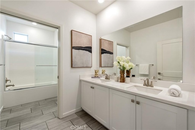 bathroom featuring vanity and shower / bath combination with glass door