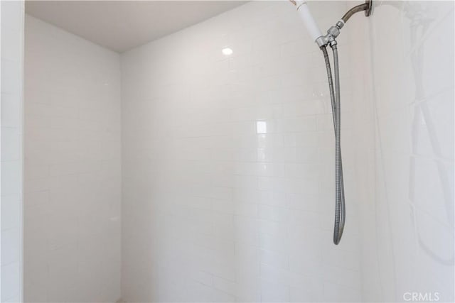 interior details featuring tiled shower