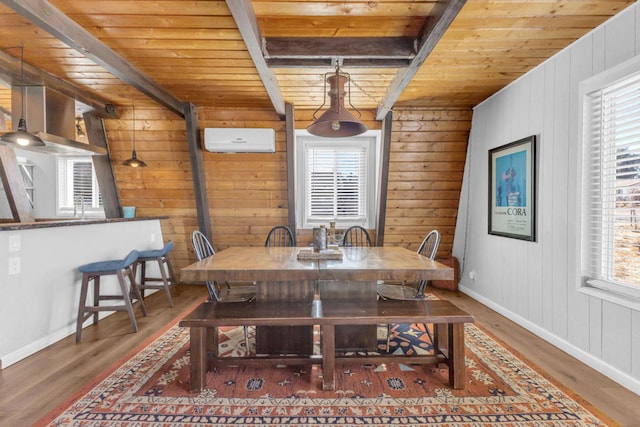 dining space featuring a healthy amount of sunlight, beam ceiling, a wall mounted AC, and wooden ceiling