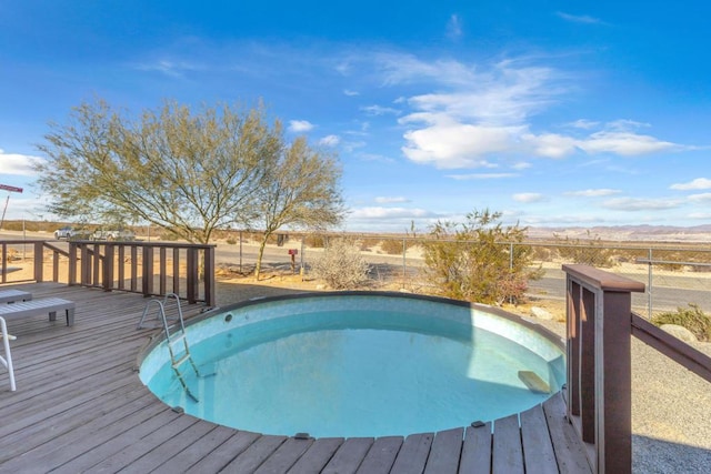 view of swimming pool featuring a deck with mountain view