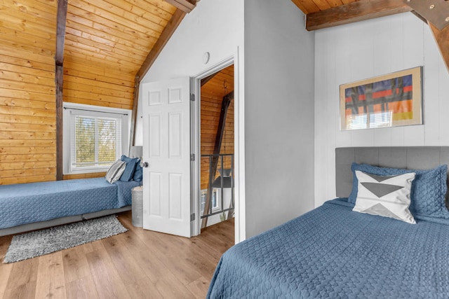 bedroom with high vaulted ceiling, wooden ceiling, light hardwood / wood-style floors, and beamed ceiling