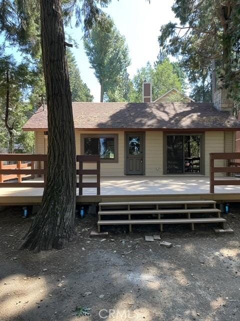 rear view of house featuring a deck