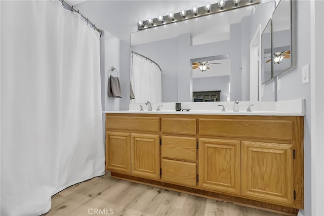 bathroom featuring ceiling fan, vanity, and hardwood / wood-style flooring