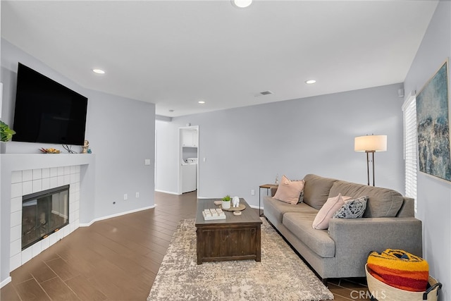 living room featuring a fireplace and dark wood-type flooring