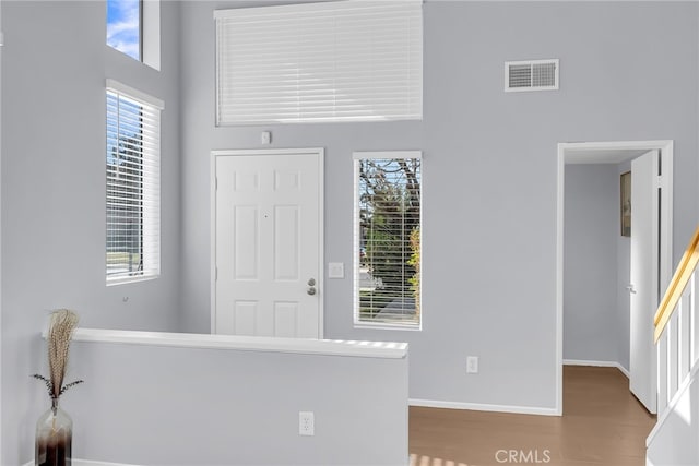 entryway with a high ceiling and hardwood / wood-style flooring