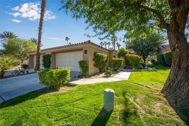 view of front of property featuring a garage and a front lawn