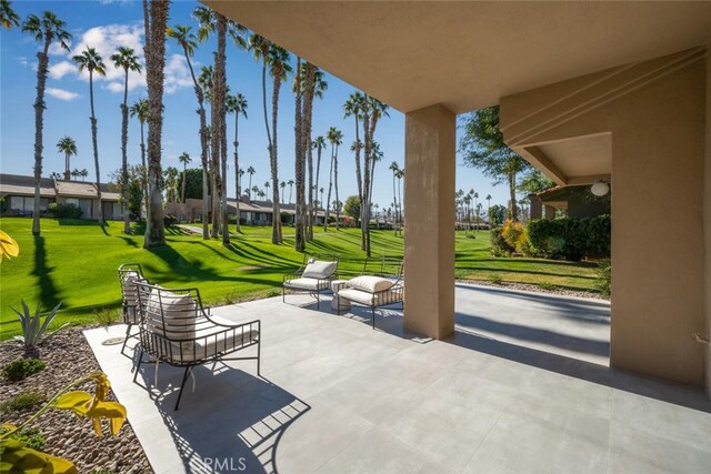 view of home's community with a patio area and a lawn