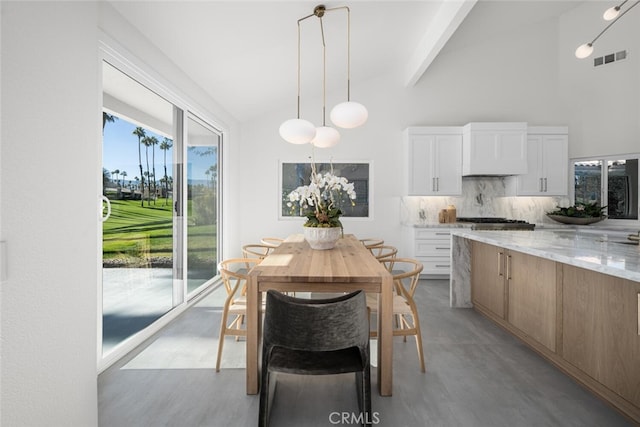 dining area with high vaulted ceiling and beamed ceiling