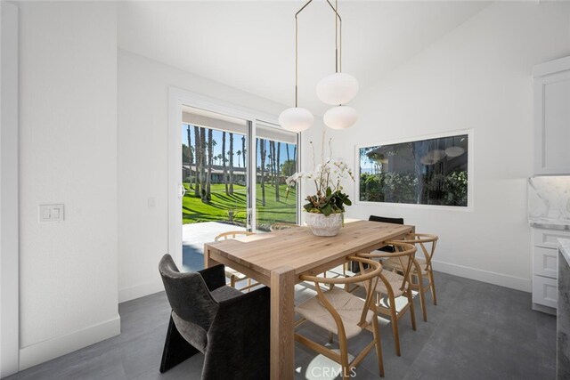 dining area featuring vaulted ceiling