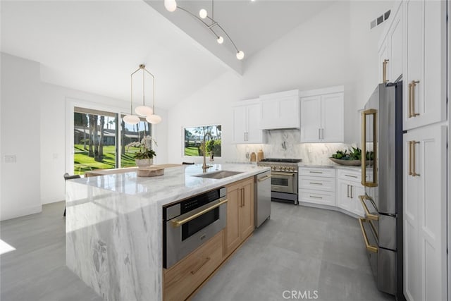 kitchen with white cabinetry, a kitchen island with sink, and stainless steel appliances