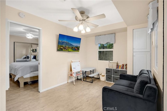 sitting room with ceiling fan and light hardwood / wood-style floors