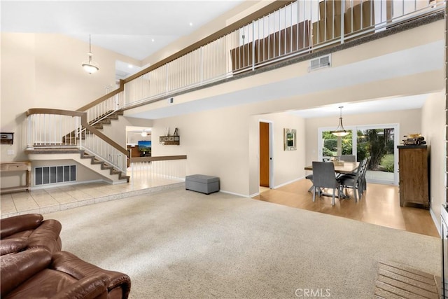 living room with a high ceiling and light hardwood / wood-style flooring