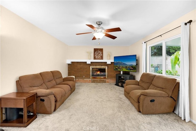 carpeted living room featuring ceiling fan and a brick fireplace