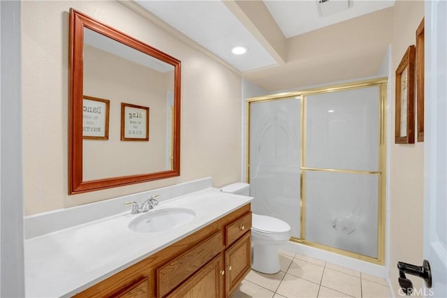 bathroom with toilet, vanity, tile patterned floors, and a shower with shower door