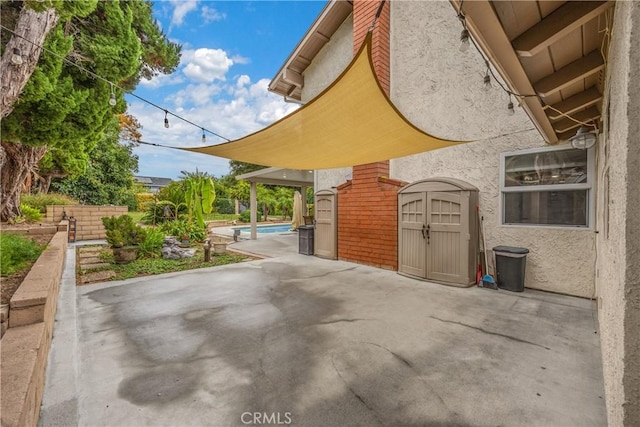 view of patio with a storage unit