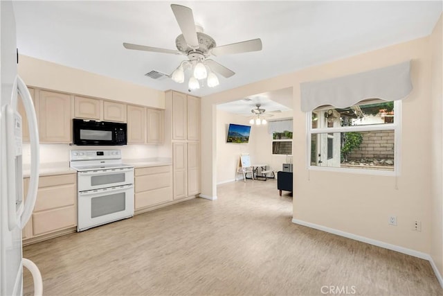 kitchen featuring light brown cabinets, white appliances, and light hardwood / wood-style flooring