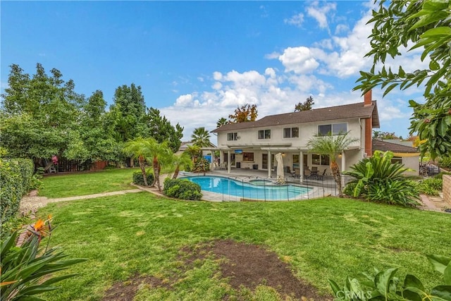 view of pool featuring a lawn and a patio