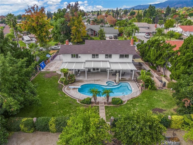 view of pool featuring a patio, a diving board, and a lawn